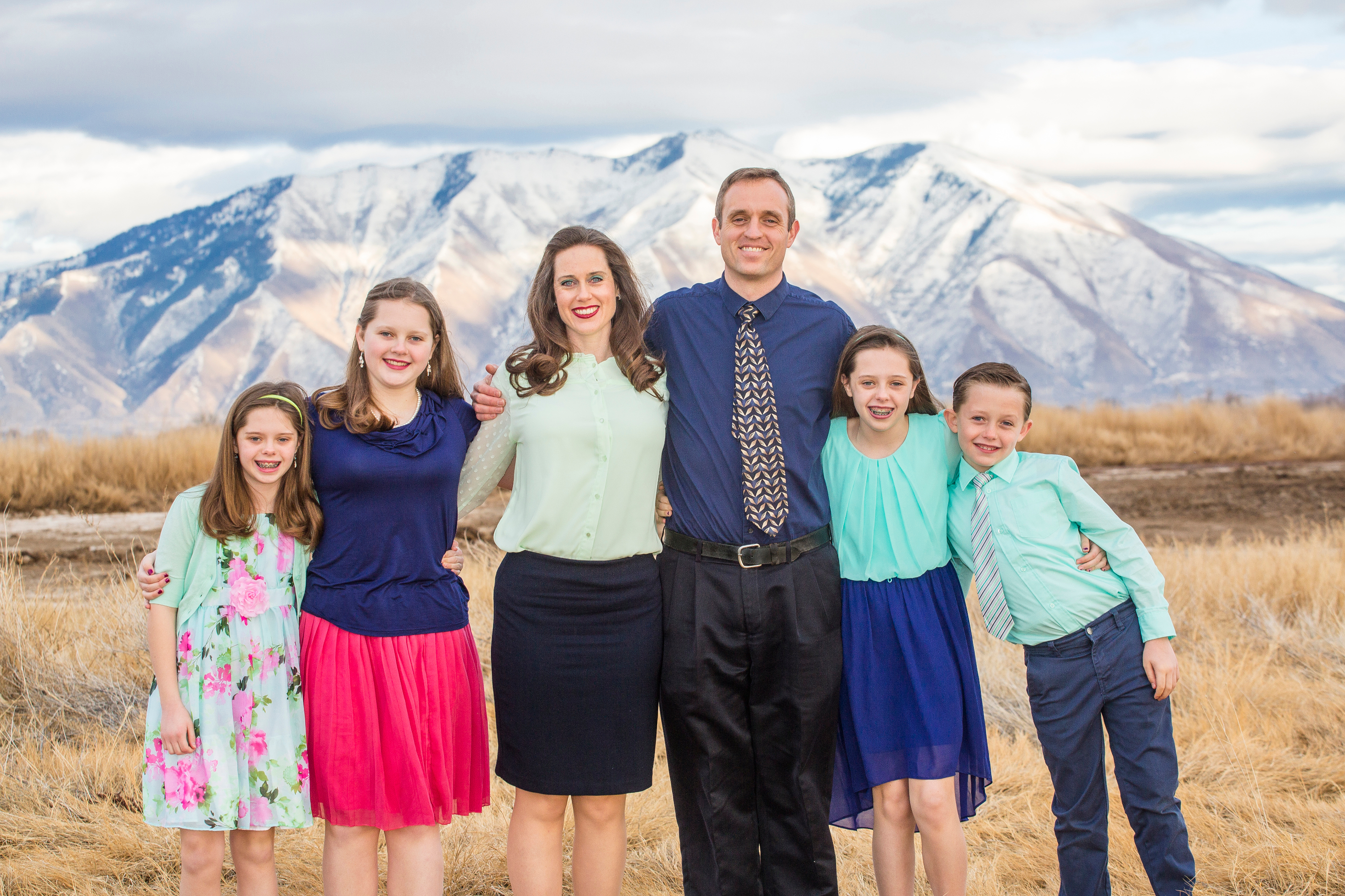 Picture of Karen and her family, beautiful mountains in the background